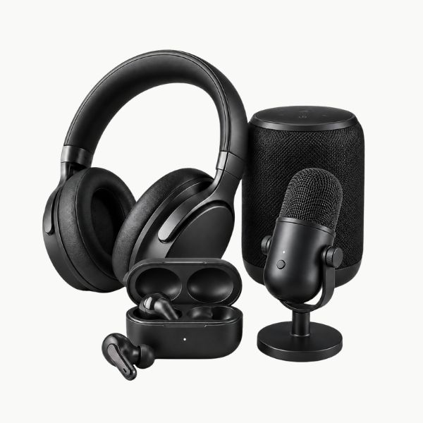 Premium black audio accessories bundle featuring over-ear headphones, wireless earbuds with charging case, portable Bluetooth speaker, and desktop microphone on a clean light background.